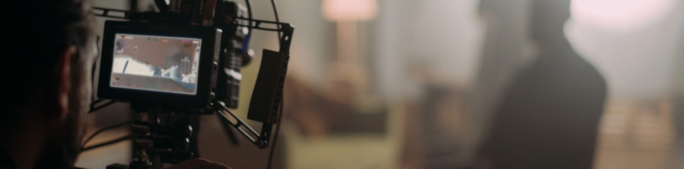 A close up of a video camera's display with a blurred background